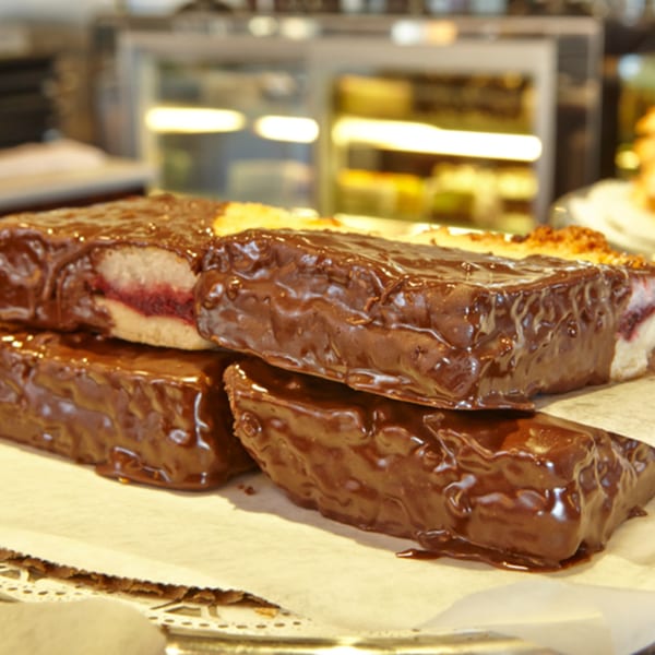 Chocolate-covered pastries with a fruit filling, displayed on a tray at Jax Inn Diner.