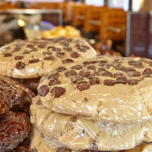 Stacks of large, plastic-wrapped chocolate chip cookies and other pastries at Jax Inn Diner.